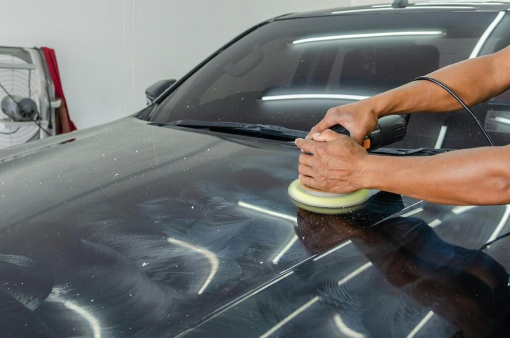 showing a technician using professional power tools to restore the shine on the vehicle's exterior.